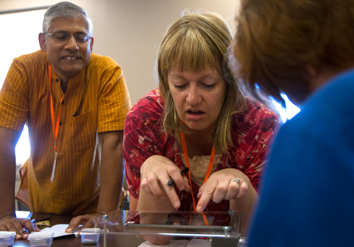 Santosh Zachariah (left) from the Evergreen School in Shoreline, Washington, and Maggie Huddleston from Sand Ridge Junior High School in Roy, Utah, examine cooking spices using a tablet microscope stand Monday, June 6. The NSCF Scholars later built their own stands to bring back to their schools. (Photo by Sam Oldenburg)