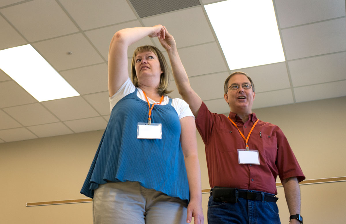 Maggie Huddleston (left) of Roy, Utah, andSKyTeach Master Instructor Rico Tyler demonstrate through dance how the moon orbits around Earth Wednesday, June 8. (Photo by Tucker Covey)