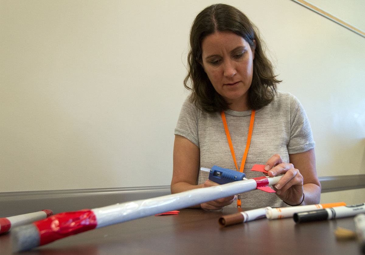 Jill Henry from Herrick Middle School in Downers Grove, Illinois, attaches foam fins to her rocket Tuesday, June 7. The NSCF Scholars built rockets using paper, tape, and foam. (Photo by Sam Oldenburg)