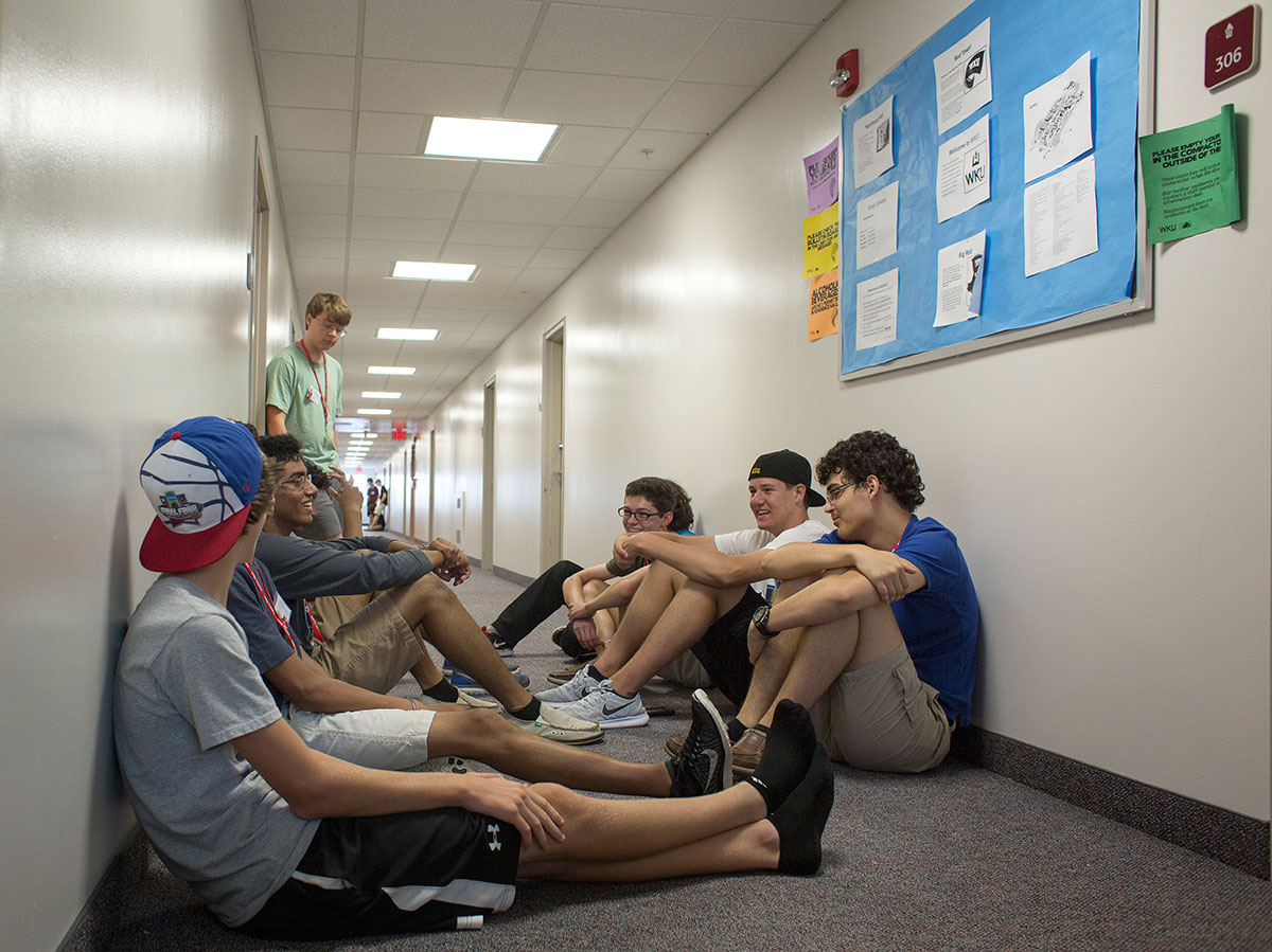 Counselor Matt Owen's group of campers sit together in Northeast Hall before their first hall meeting Sunday, June 26. (Photo by Tucker Allen Covey)