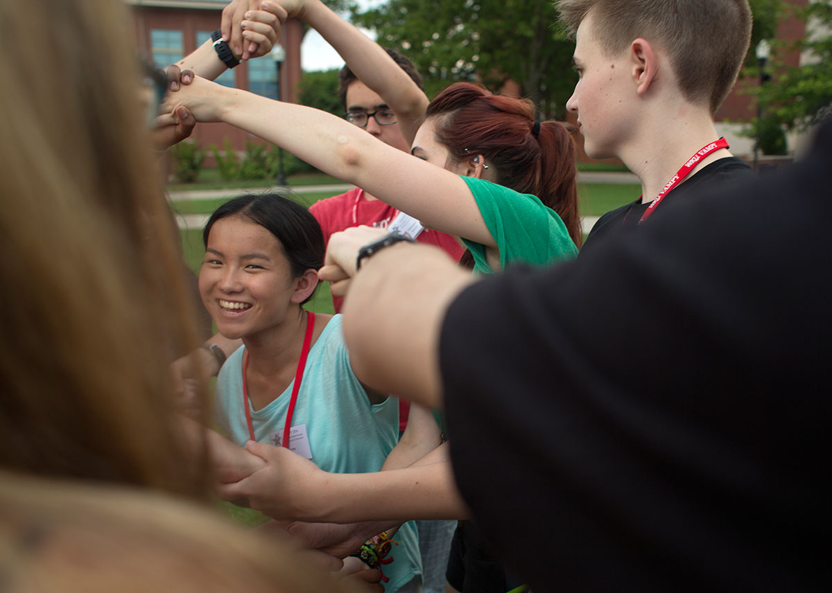 Grace Martini from Shepherdsville helps her group untie a human knot during icebreakers on Sunday, June 26. (Photo by Tucker Allen Covey)