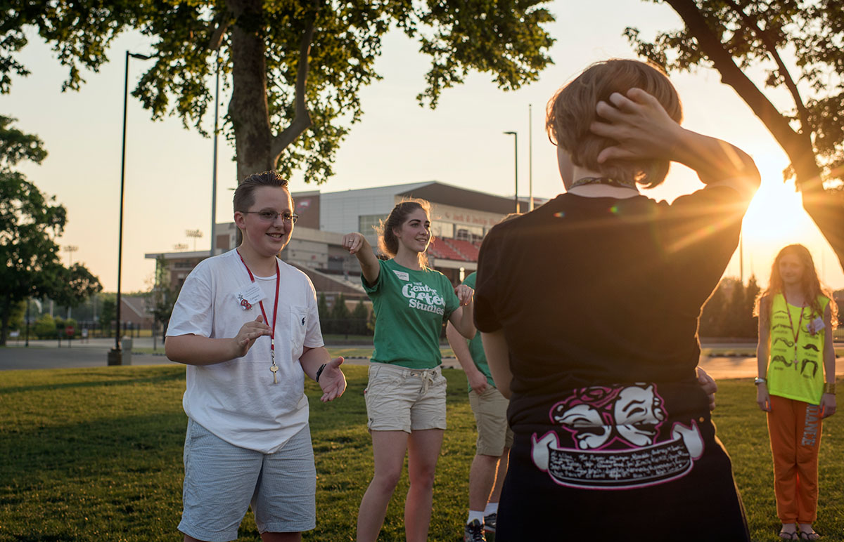 Calloway Bills (left) of Russellville plays Pterodactyl with counselor Olivia Jacobs and other campers on South Lawn Sunday, June 12. The goal of the ice-breaker game was to make an opposing player smile by saying pterodactyl in an awkward way. (Photo by Tucker Allen Covey)