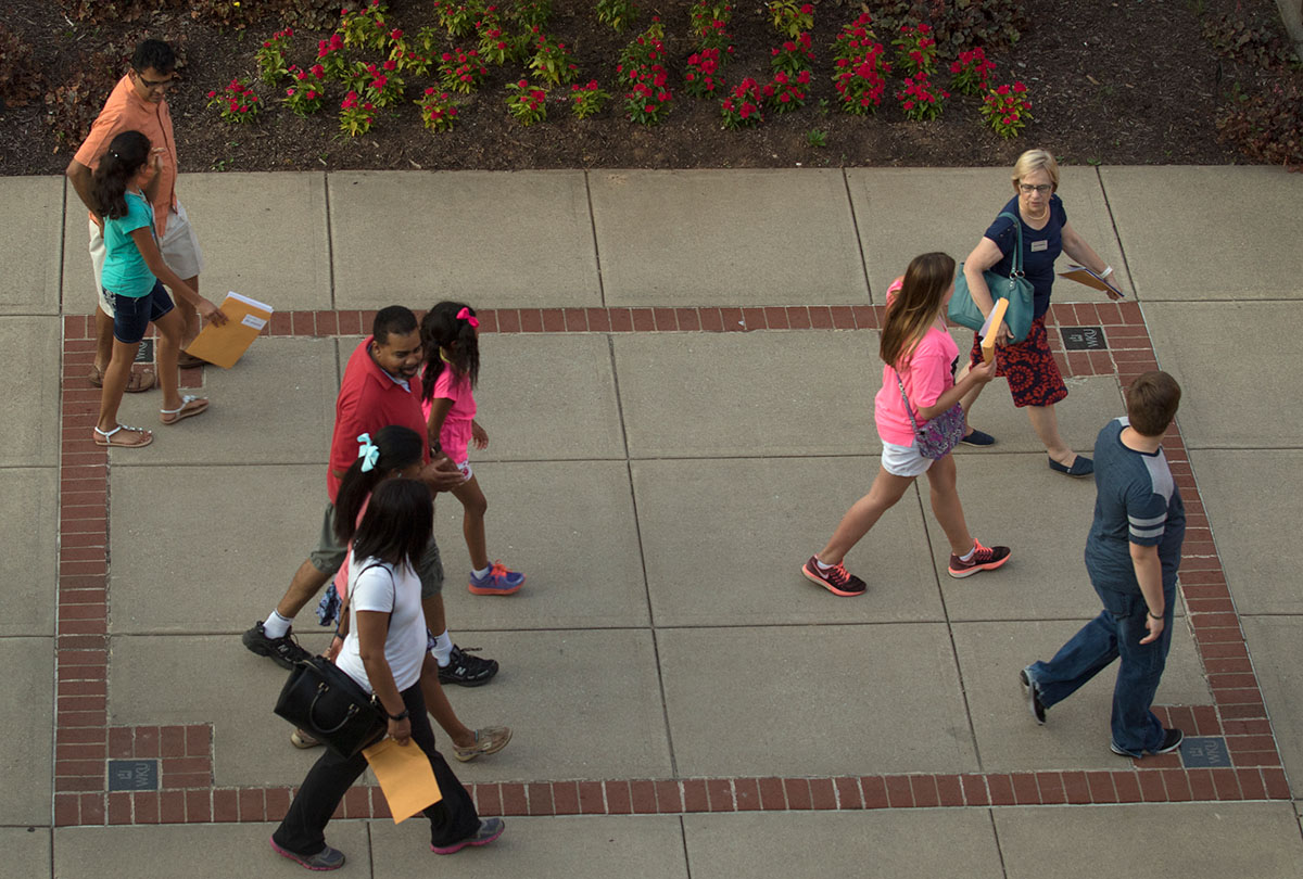 Julie Roberts, the executive director of The Center for Gifted Studies, leads non-residential students on a campus tour Sunday, June 12, in preparation for their first classes the following morning. (Photo by Sam Oldenburg)