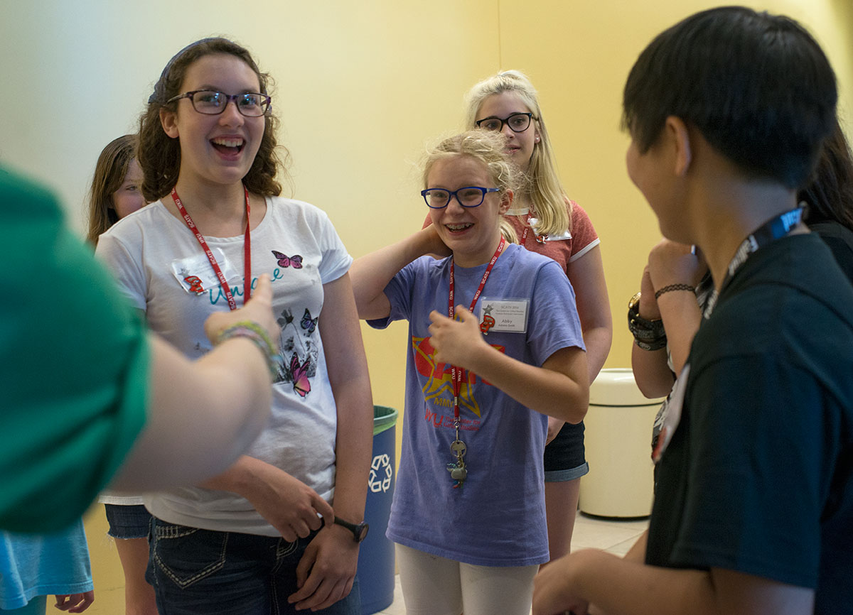 Abby Adams-Smith (center) starts laughing after stumbling over words in her introduction while her fellow campers laugh along in good spirits Sunday, June 12. (Photo by Tucker Allen Covey)