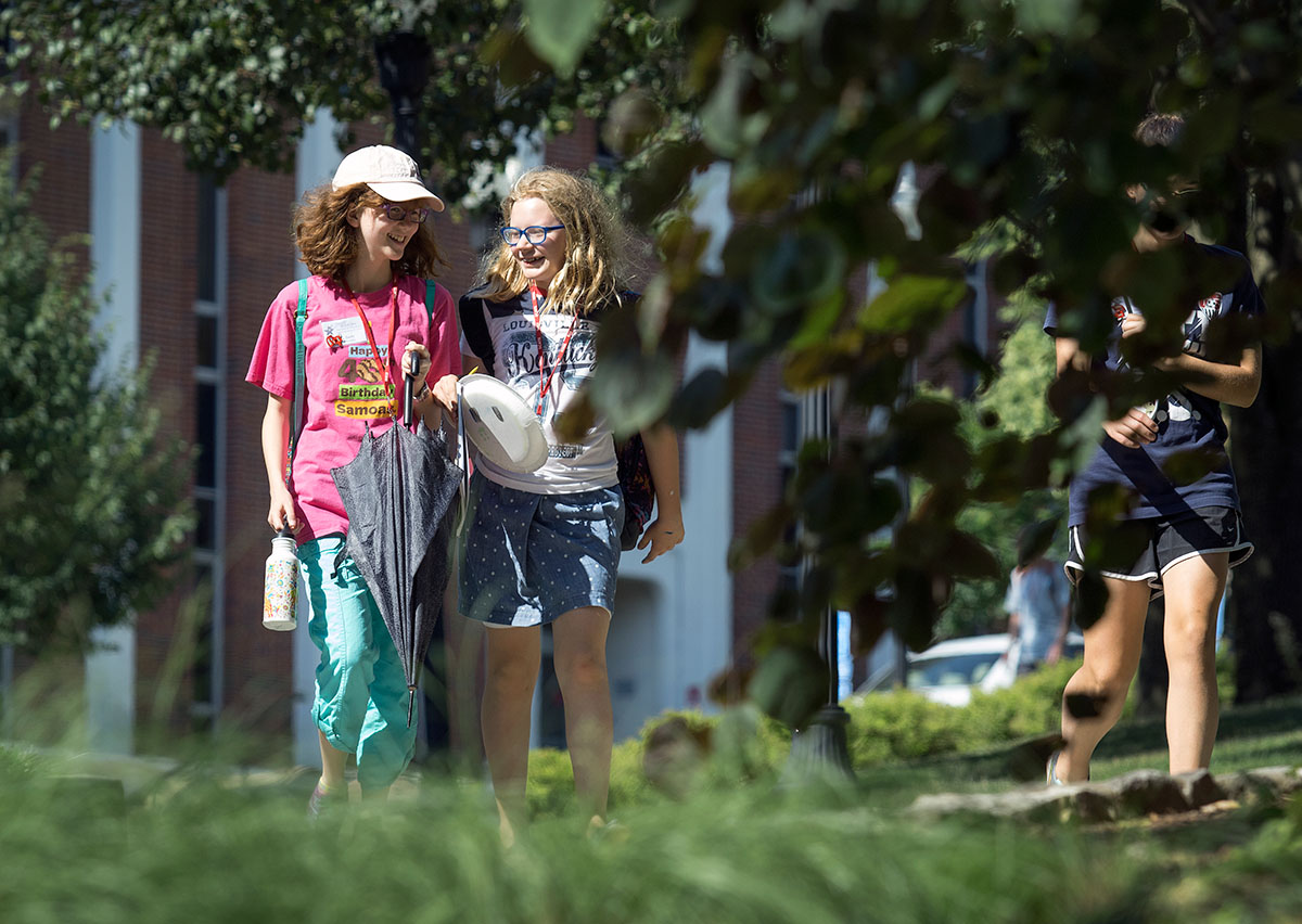 Sachi Barnaby (left) and Abby Adams-Smith, both of Bowling Green, talk with each other while walking back to Northeast Hall after their last class of the day Monday, June 20. (Photo by Sam Oldenburg)
