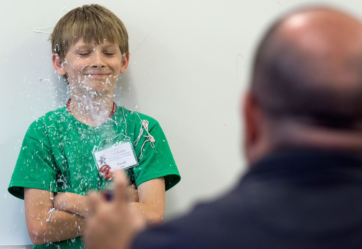 David Abel of Owenboro braces to be sprayed with silly string while delivering an extemporaneous speech in Public Speaking Friday, June 17. The teacher, Kevan Brown, sprayed students if they used any filler words, such as like, and, or um. (Photo by Sam Oldenburg)