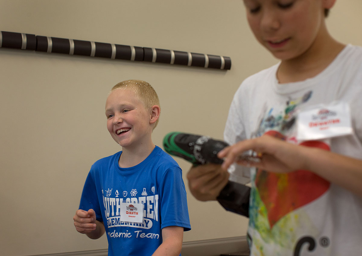 Quentin Grieshop laughs after getting covered in styrofoam pieces while constructing a prototype of an invention meant to solve a real-world problem during Science at Camp Innovate Thursday, June 9. (Photo by Tucker Allen Covey)