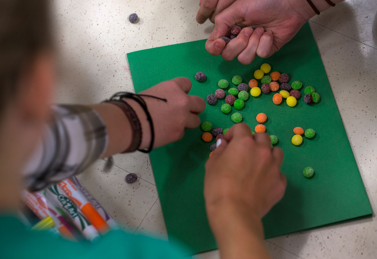 Acting students select Skittles before using them to answer specific questions according to the candy's color on Monday, June 13. (Photo by Tucker Allen Covey)