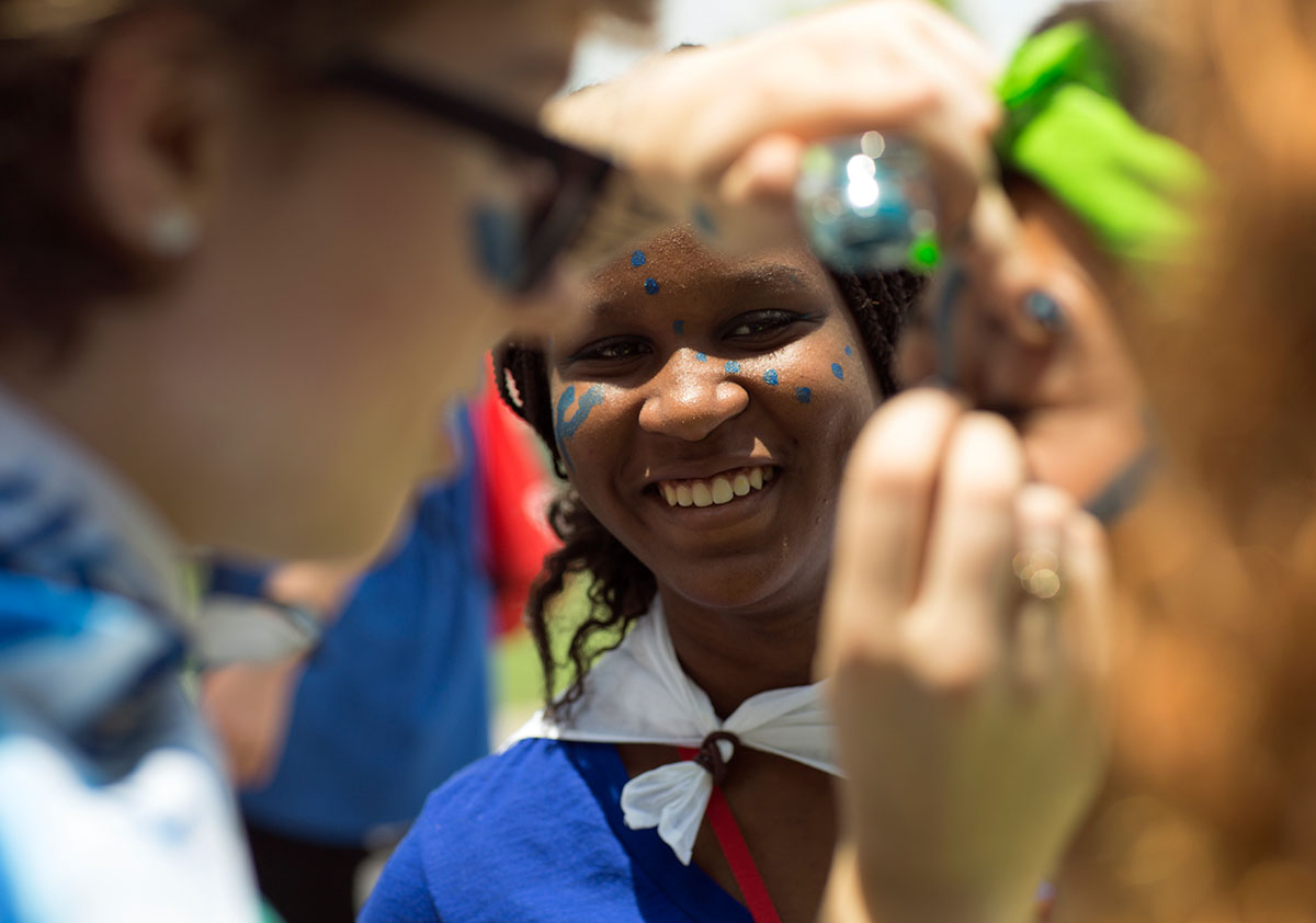 Aneesha Edwards from Lexington watches as her teammates on Team Atlantis paint up before the SCATS Olympics Saturday, June 18. (Photo by Tucker Allen Covey)