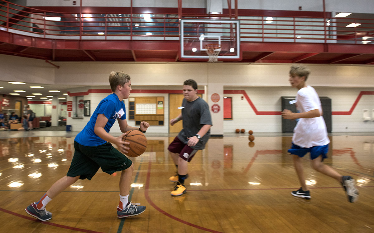Teague Howell (from left) of Louisville, Blake Johnson from Madisonville, and Patrick Stiltner from Versailles play basketball in the Preston Center during the free time given to SCATS campers Friday, June 17. (Photo by Tucker Allen Covey)