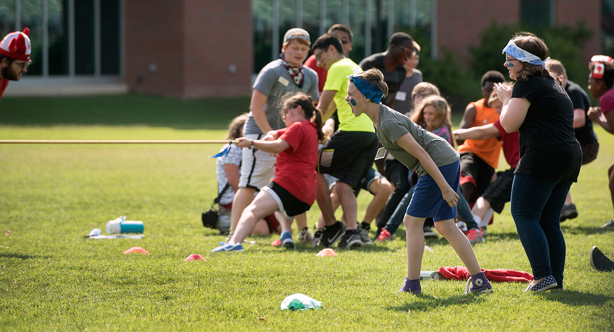 Riley Whittington (middle left) from Louisville cheers on her teammates on Team Atlantis during the tug-of-war competition at SCATS Olympics Saturday, June 18. (Photo by Tucker Allen Covey)