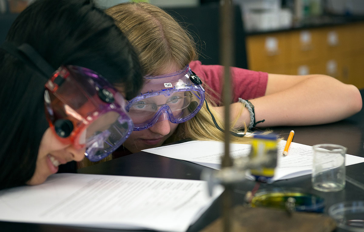 Yunni Qu (left) from Bowling Green and Sarah Herrell of Hopkinsville watch as their solution begins to dramatically change colors in Chemistry on Thursday, June 30. (Photo by Tucker Allen Covey)