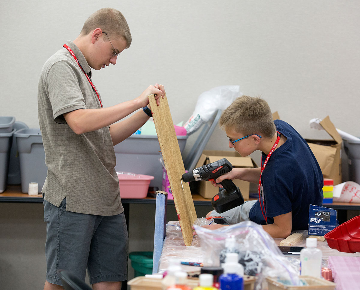 Kevin Eastman (left) from Bowling Green and Will Sayler from Spearfish, South Dakota, work together to build part of their Rube Goldberg Machine requiring robotics and a specified allotment of duct tape on Thursday, June 30. (Photo by Tucker Allen Covey)