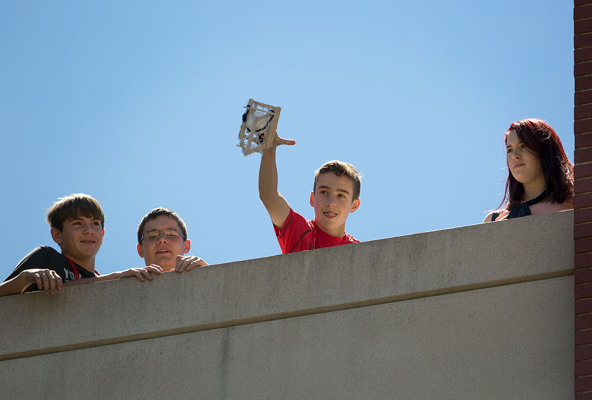 Ethan Rutter from Bowling Green drops his egg drop creation which campers in the Problems You Have Never Solved Before class built to certain specifications and then dropped from the roof of Parking Structure 2 on Wednesday, June 29. (Photo by Tucker Allen Covey)