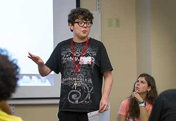 Christian Butterfield of Bowling Green argues against school uniforms while his partner, Emily Jones of Lexington, listens to his points during a practice debate in Competitive Forensics Tuesday, July 5. (Photo by Sam Oldenburg)