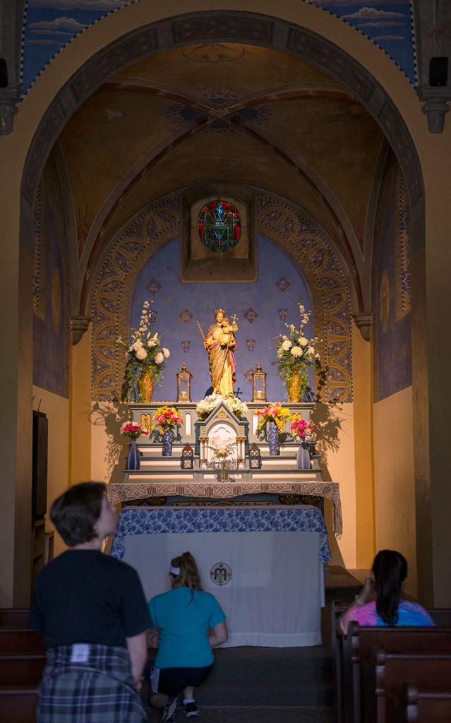 Humanities students genuflect in front of the altar in the Monte Cassino Shrine on the grounds of Saint Meinrad Archabbey in Saint Meinrad, Ind., Tuesday, July 5. (Photo by Tucker Allen Covey)