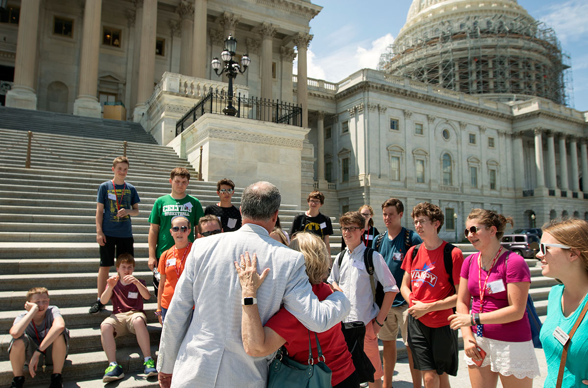 Congressman Brett Guthrie embraces Julia Roberts, the executive director of The Center for Gifted Studies, outside the United States Capitol in Washington D.C. Wednesday, July 6. Brett, who is a member of The Center's advisory board, led the Presidential Politcs class on a personal tour of the Capitol.  (Photo by Sam Oldenburg)