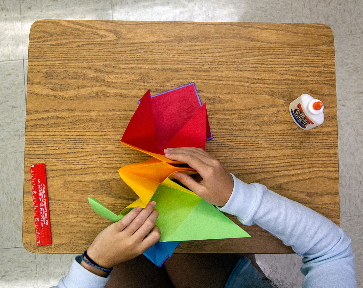 Lee-Lee Knupp of Russell folds an origami book during Mathematics Friday, July 1. (Photo by Sam Oldenburg)