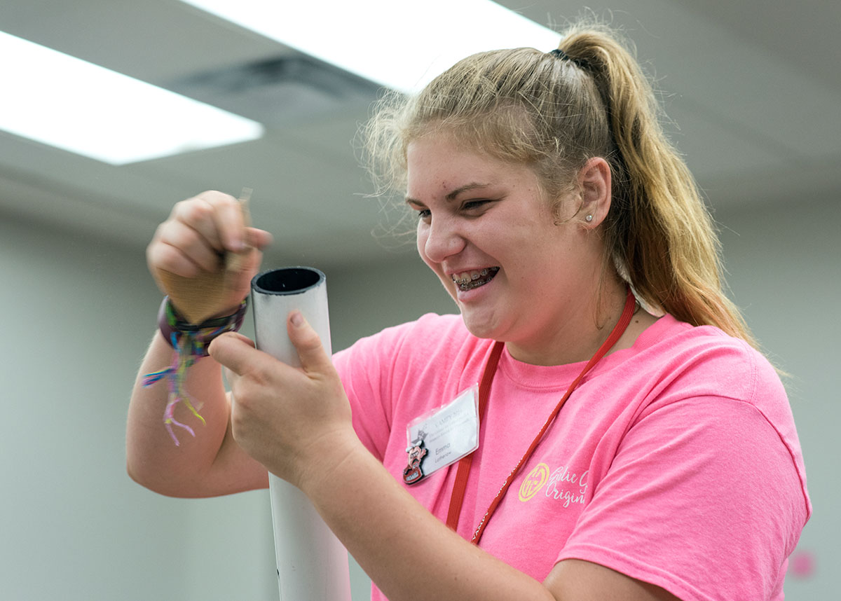 Emma Latherow from Ashland sands down the edges of a PVC tube used to build part of her telescope in Astronomy on Wednesday, July 6. (Photo by Tucker Allen Covey)
