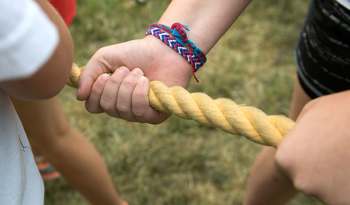 A friendship-bracelet-clad camper prepares for tug-of-war competition during the VAMPY Olympics Games Saturday, July 2. (Photo by Tucker Allen Covey)