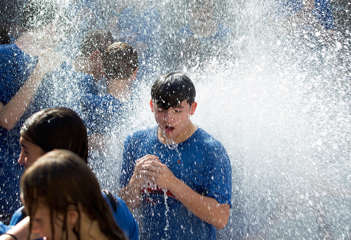 Campers take the traditional run through the fountain outside Margie Helm Library after the last day of classes Friday, July 15. (Photo by Sam Oldenburg)