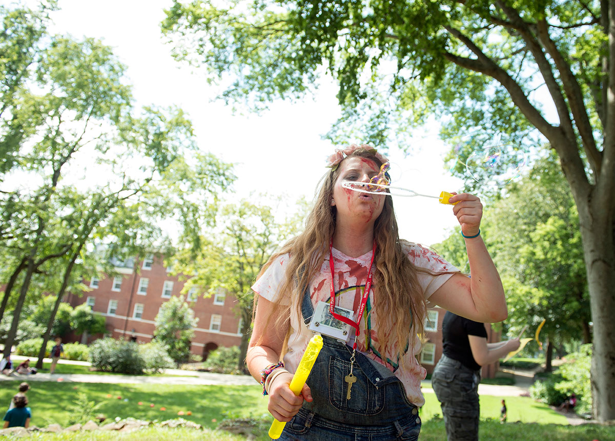Rhianon Hussung of Louisvile blows bubbles behind Grise Hall during V-Con Saturday, July 9. (Photo by Tucker Allen Covey)