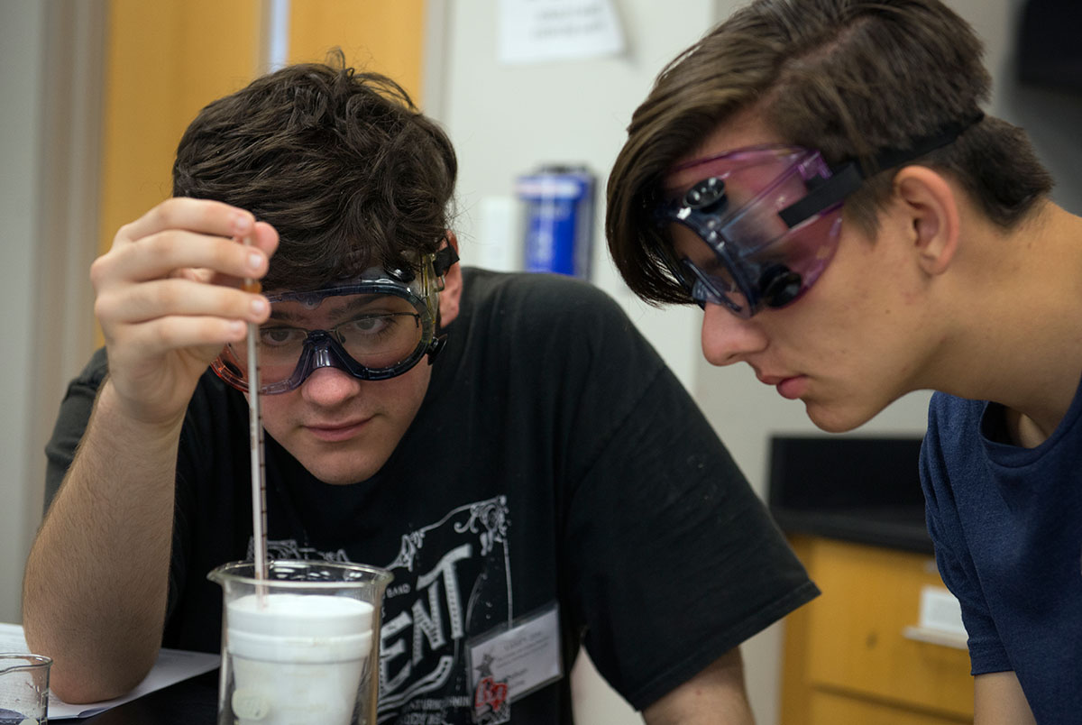 Nathan Bowling (left) from Lexington, S.C., works with Nick Stone from Frankfort to check the temperature of a solution they made in Chemistry Friday, July 8. (Photo by Tucker Allen Covey)