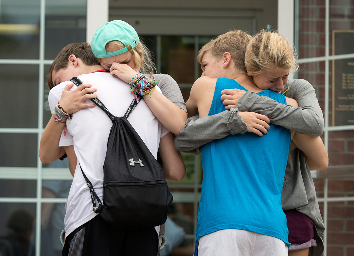 Tanner Pruitt (from left) of Louisville, Gracie Hobbs of Owensboro, Kyzick Schweppe of Mount Juliet, Tenn., and Olivia Bickett of Owensboro hug goodbye during checkout Saturday, July 16. (Photo by Sam Oldenburg)