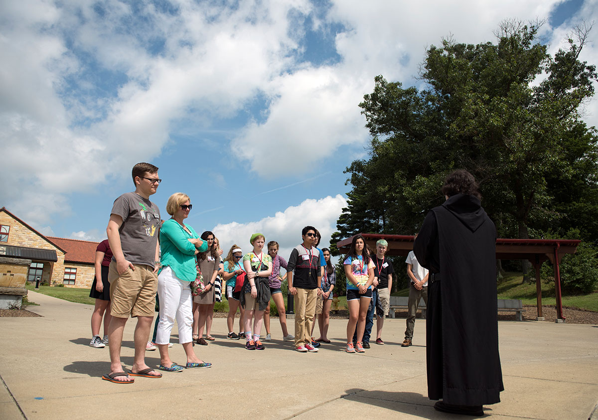 Humanities students listen to Brother Jean Fish, a monk of Saint Meinrad Archabbey, while on a tour of the Catholic monastery in Saint Meinrad, Ind., Tuesday, July 5. (Photo by Tucker Allen Covey)