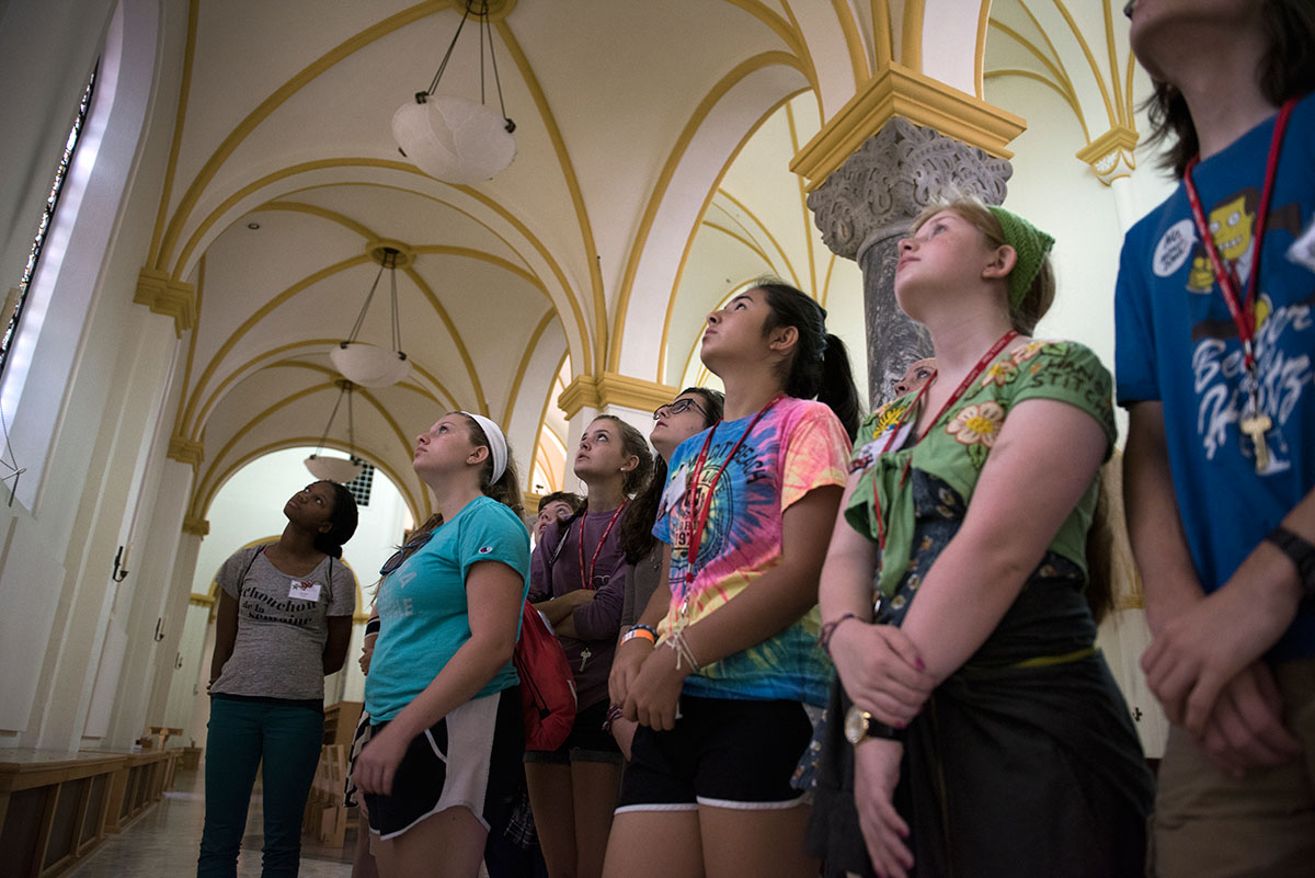 Humanities students look up at the stained glass windows in the Archabbey Church at Saint Meinrad Archabbey, a Catholic monastery in Saint Meinrad, Ind., Tuesday, July 5. (Photo by Tucker Allen Covey)