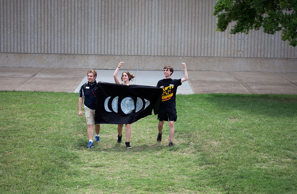 Counselors Seth Marksberry (from left), Olivia Jacobs, and Ben Guthrie represent the Lunar Union during the opening ceremonies of VAMPY Olympics Saturday, July 2. (Photo by Tucker Allen Covey)