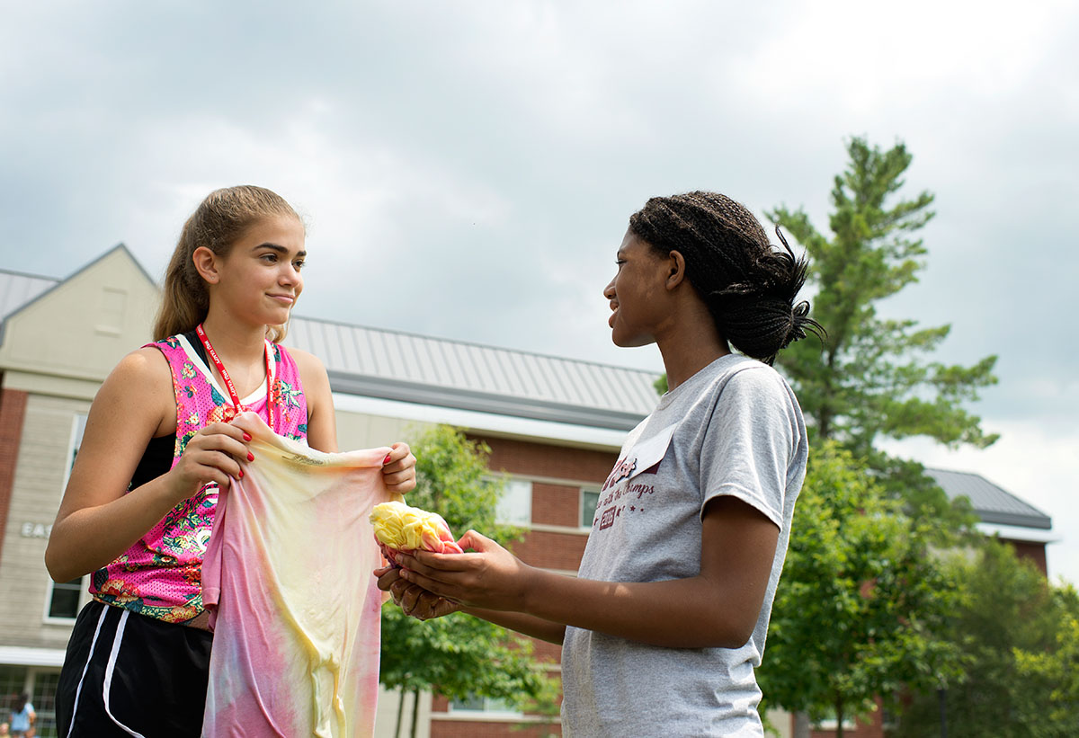 Maya Abul-Khoudoud (left) from Ashland and Jocelyn Martin from Russell inspect their tie-dyed shirts during VAMPY Stock on Sunday, July 3. (Photo by Tucker Allen Covey)