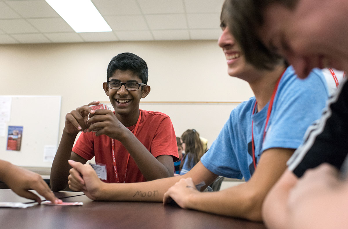 Rohan Jaisinghani (center) from Brentwood, Tennessee, plays a card game with fellow campers after Paper Theatre Saturday, July 2. (Photo by Tucker Allen Covey)