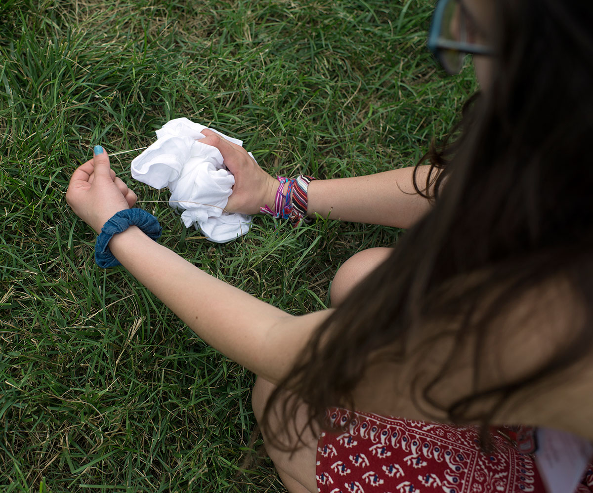 Martha Popescu from Hanson prepares her shirt before dunking it into the tie-dying buckets during VAMPY Stock on Sunday, July 3. (Photo by Tucker Allen Covey)