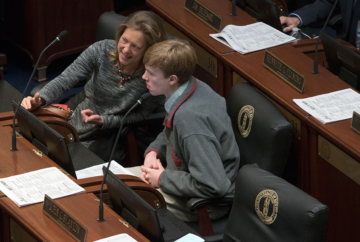 Representative Kelly Flood of Lexington speaks with Gatton Academy senior Tyler Smith on the floor of the House of Representatives while the House is in session. (Photo by Sam Oldenburg)