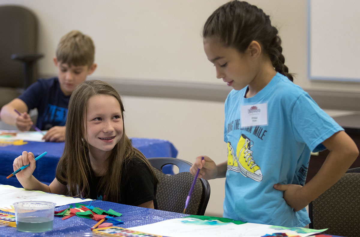 Danika Miller (left) and Itzli Perez paint trees during Art Tuesday, June 6. The class learned different watercolor techniques and used them to create their own landscapes. (Photo by Brook Joyner)