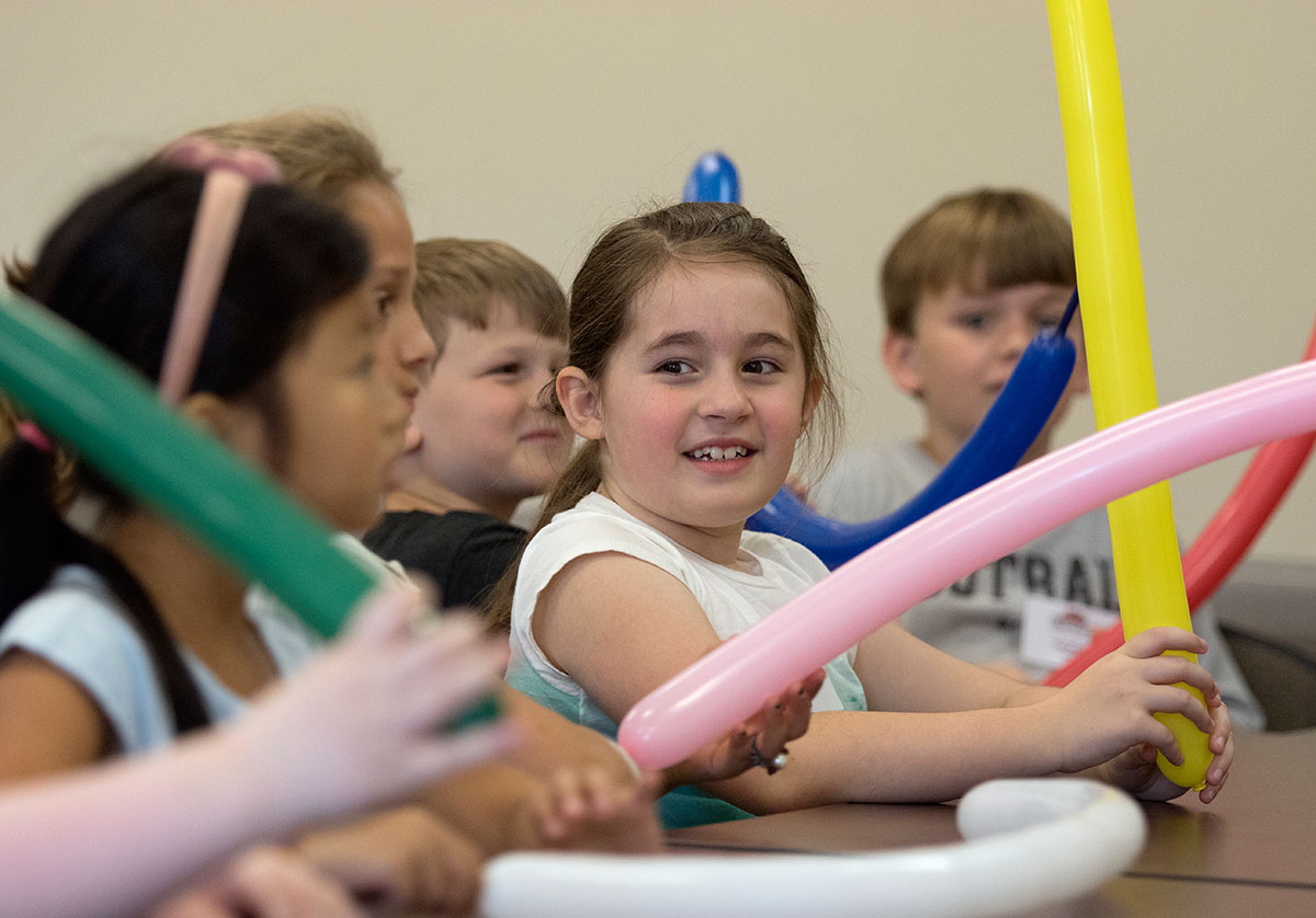 Sarah Pannell learns how to make balloon animals during Clowning on Tuesday, June 6. (Photo by Brook Joyner)