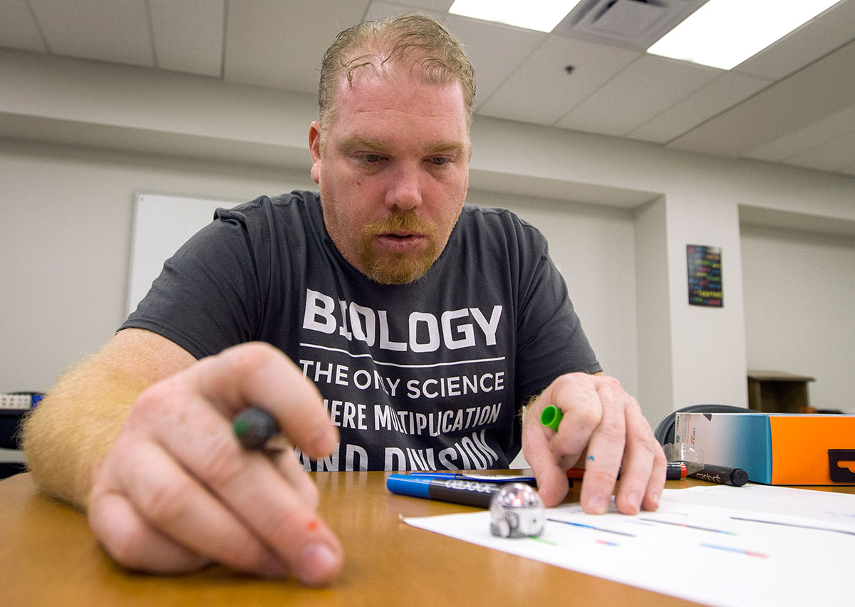 Jay Hollis from Brownsville tests the codes he drew to control an Ozobot Thursday, June 8. The Ozobots were used as mock bacteria, and the NSCF Scholars explored codes as mock DNA sequences to control the "bacteria." (Photo by Sam Oldenburg)