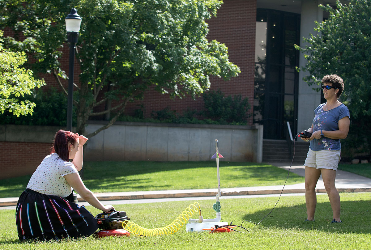 Emily McKernan, from Dickinson Center, N.Y., tests her rocket on Tuesday, June 6. The rockets were made from paper, tape, and foam. (Photo by Brook Joyner)