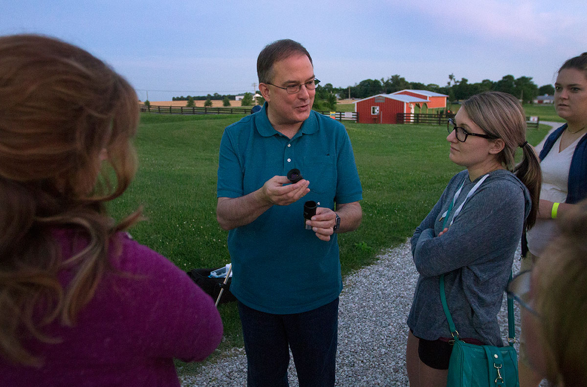 SKyTeach master teacher Rico Tyler explains telescope eyepieces to the NSCF Scholars before setting up a telescope for the scholars to use after sunset at Chaney's Dairy Barn outside Bowling Green Tuesday, June 6. Rico has taught physical science lessons to the scholars throughout the week. (Photo by Sam Oldenburg)