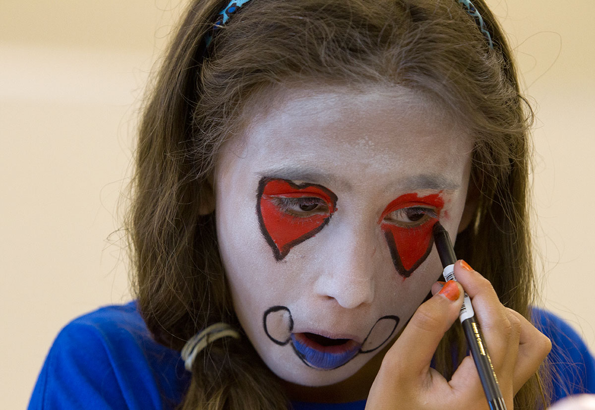 Natalie Kantosky outlines her makeup during Clowning at Camp Explore Friday, June 9. Students designed their own clown faces on paper before applying them to their faces. (Photo by Sam Oldenburg)