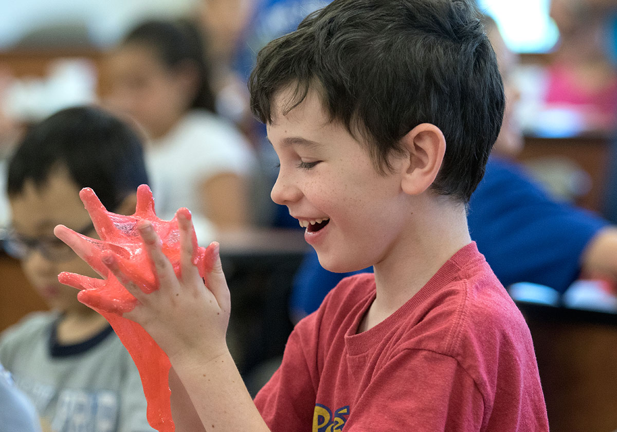 Konnor Andrew plays with the slime he made during the presentation from guest scientist "Miss Information" on Wednesday, June 7 during Camp Explore. (Photo by Brook Joyner)