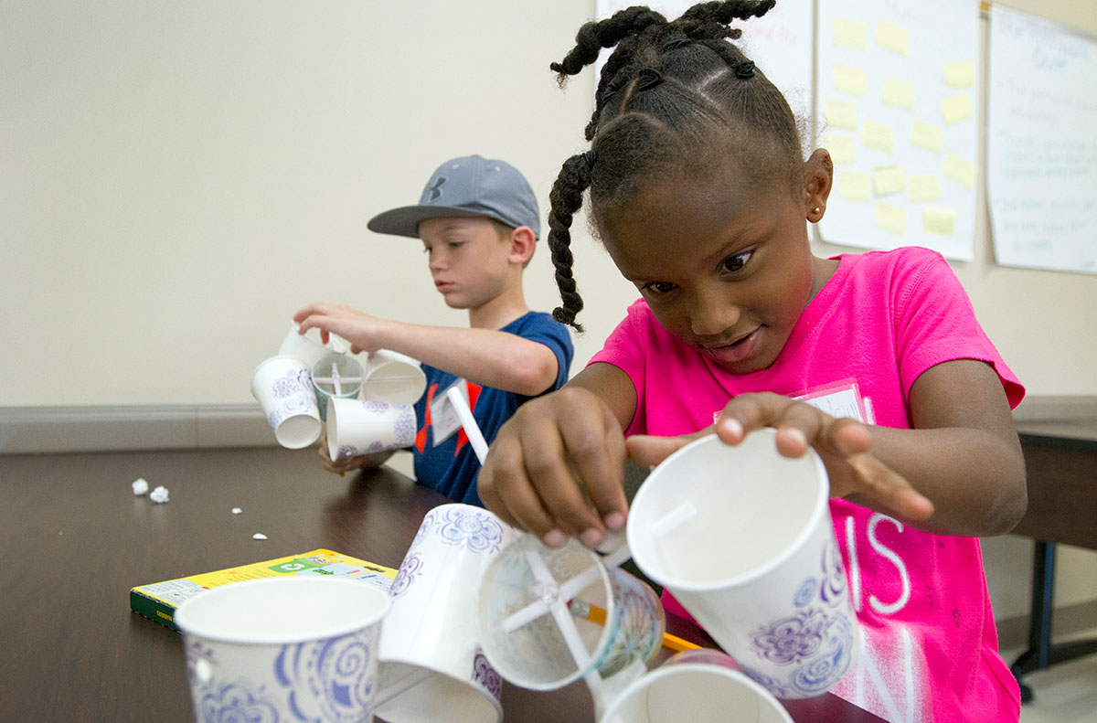 Alysa Jones attaches paper cups to straws while making an anemometer in Science during Camp Explore Thursday, June 8. (Photo by Sam Oldenburg)