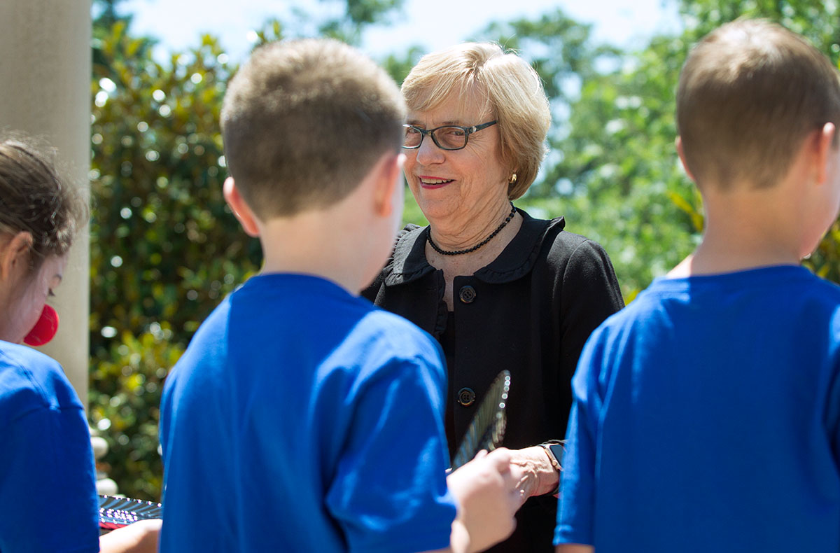 Executive Director of The Center for Gifted Studies Julia Roberts visits with students at Camp Explore while serving fruit during lunch Friday, June 9. (Photo by Sam Oldenburg)