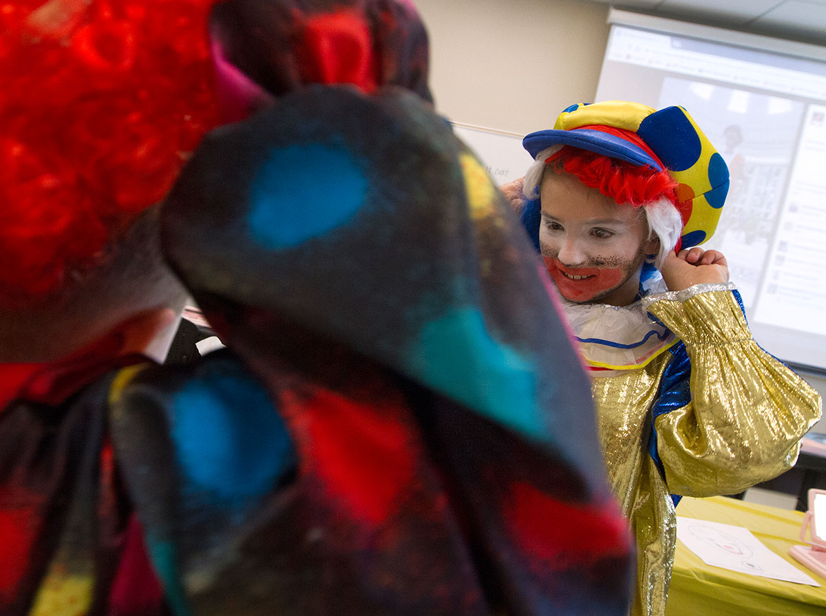Camp Explore students adjust their costumes before a group photo in Clowning Friday, June 9. (Photo by Sam Oldenburg)
