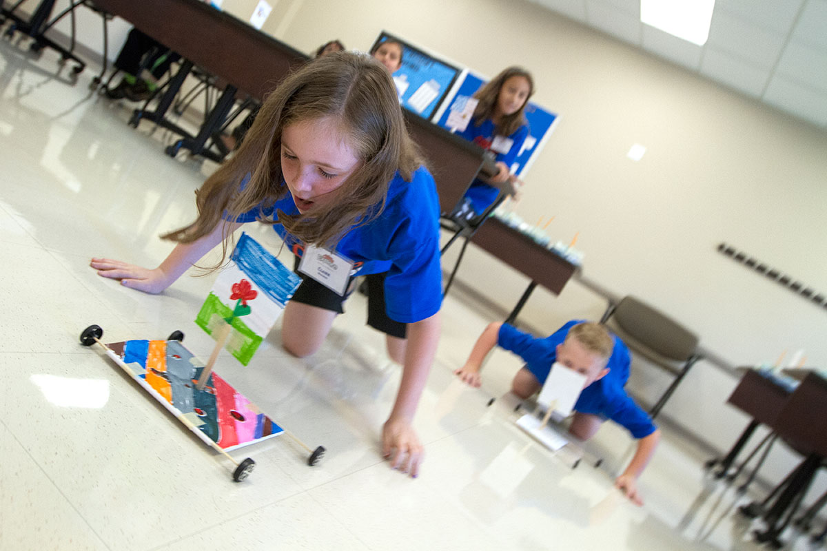 Claire Boggess races her wind-powered vehicle during Science at Camp Explore Friday, June 9. (Photo by Sam Oldenburg)