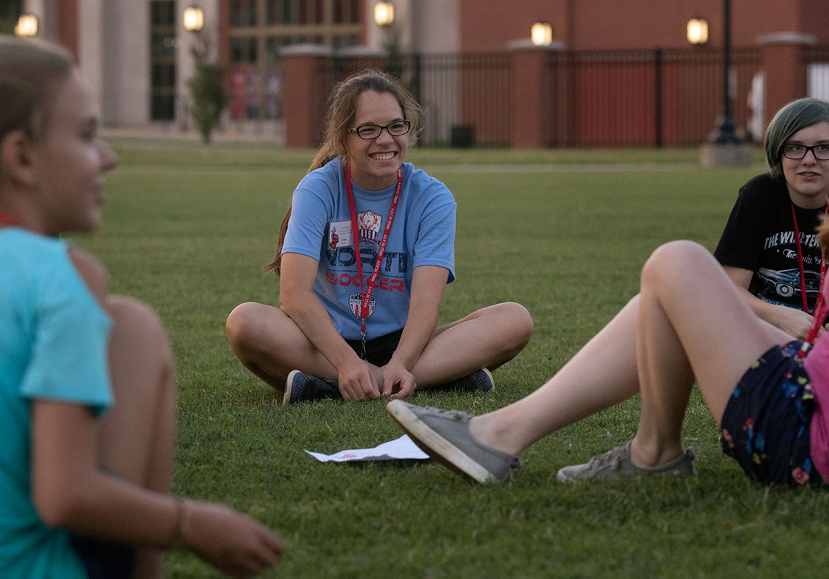 Jaime Morris of Maryville, Tenn., laughs with fellow campers during an icebreaker Sunday, June 11. For this game campers had to find things they had in common with one another. (Photo by Brook Joyner)