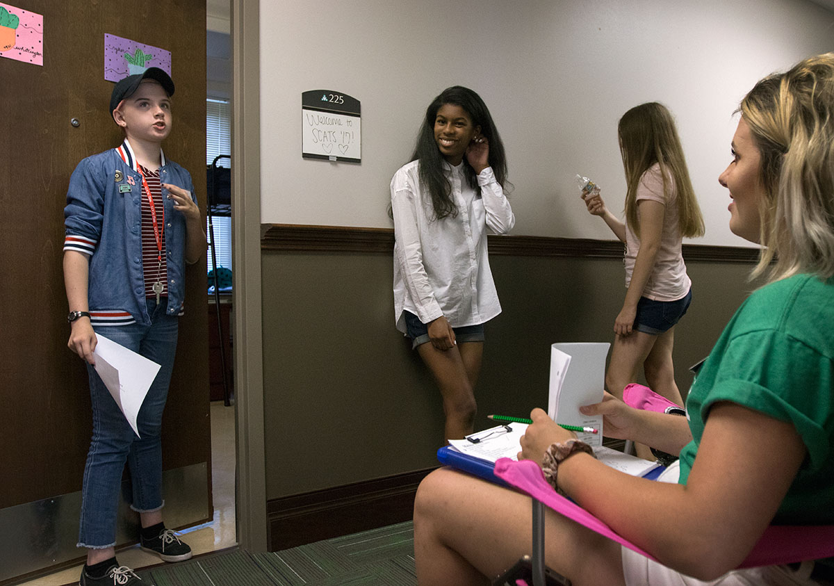Venus Whittington (from left), of Louisville, Olivia Moore, and Hannah Greenway, both of Bowling Green, talk with their counselor, Maddie Hamblin, after moving into their rooms Sunday, June 11. After all of the girls were moved in, Maddie held a hall meeting to meet the rest of the girls and to go over the rules with them. (Photo by Brook Joyner)
