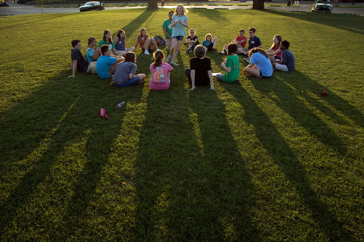 Molly Clements (center) of Villa Hills plays an icebreaker game with fellow campers on the first evening of SCATS Sunday, June 11. Pairs of counselors chose a game to play, and the campers rotated among the groups. (Photo by Brook Joyner)