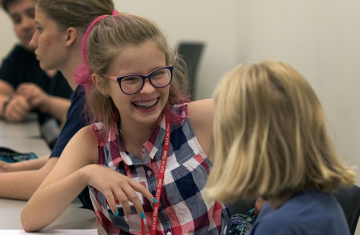 Lainey Wilemon, of Saint Petersburg, Fla., laughs with her classmate Molly Clements of Villa Hills in The Civil War: Rediscovering a Torn Nation Monday, June 12. The class tested their prior knowledge of the civil war and played a game to get to know one another. (Photo by Brook Joyner)
